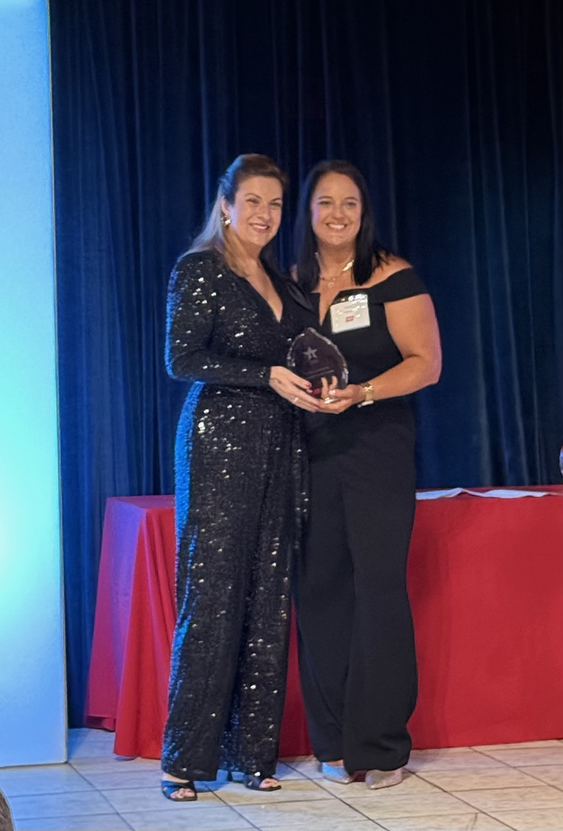 Lu Hickman accepting the 2025 HBMA Lantern Award on stage